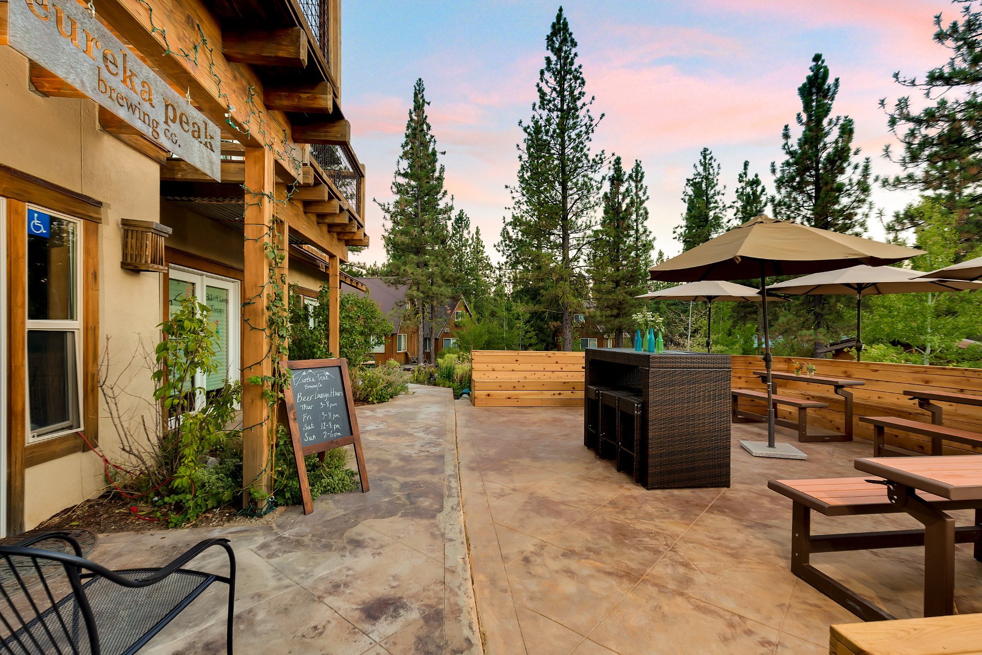 Eureka Peak Brewing Co. — outdoor patio at sunset with string lights and Sierra pines