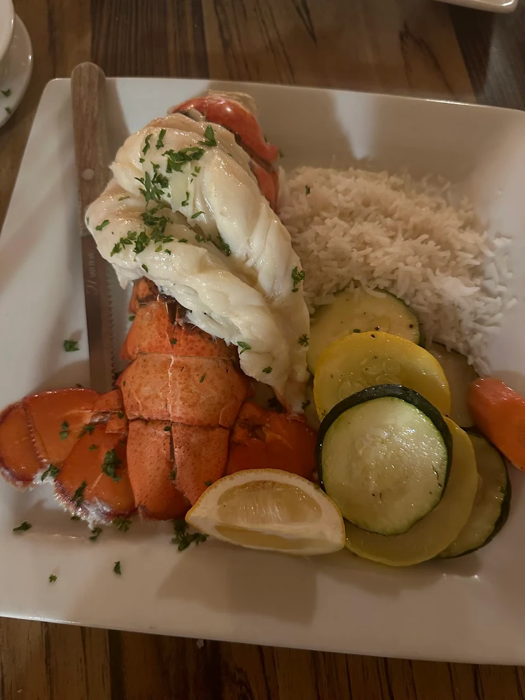 Iron Door Restaurant — fresh lobster tail with rice and grilled vegetables