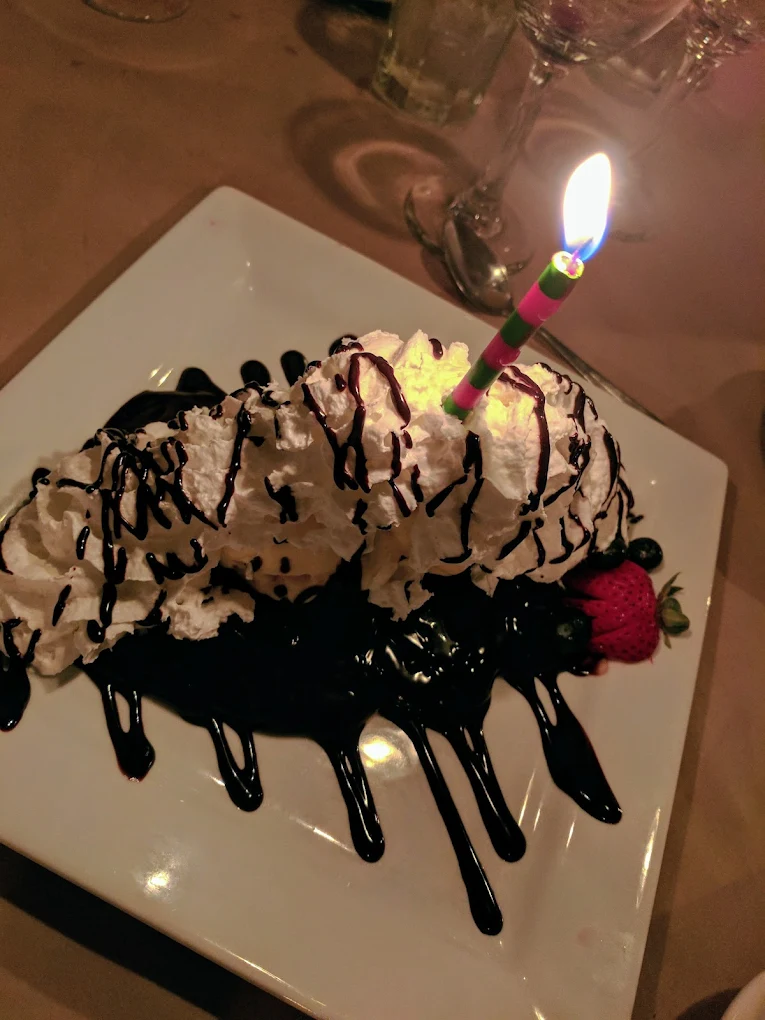 Iron Door Restaurant — birthday dessert with whipped cream, chocolate drizzle and fresh strawberries